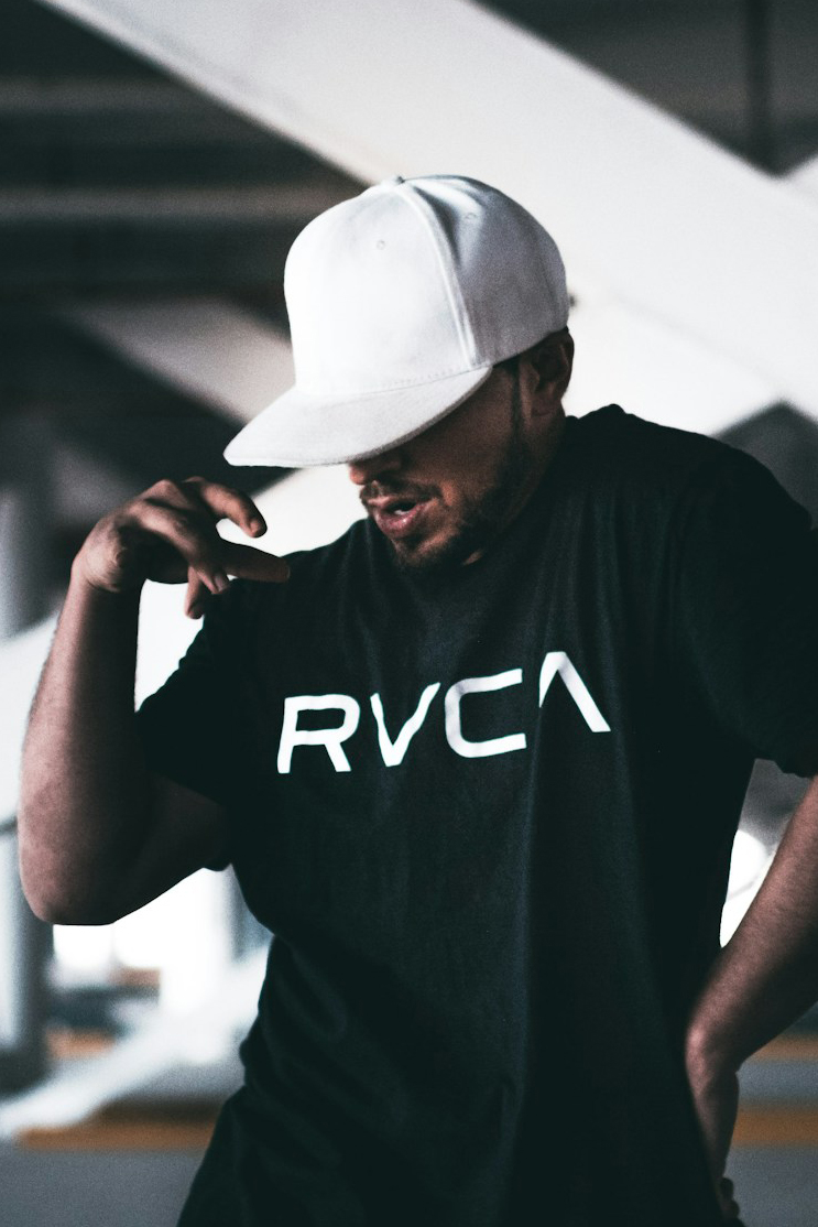 man  in ballcap dances in parking lot