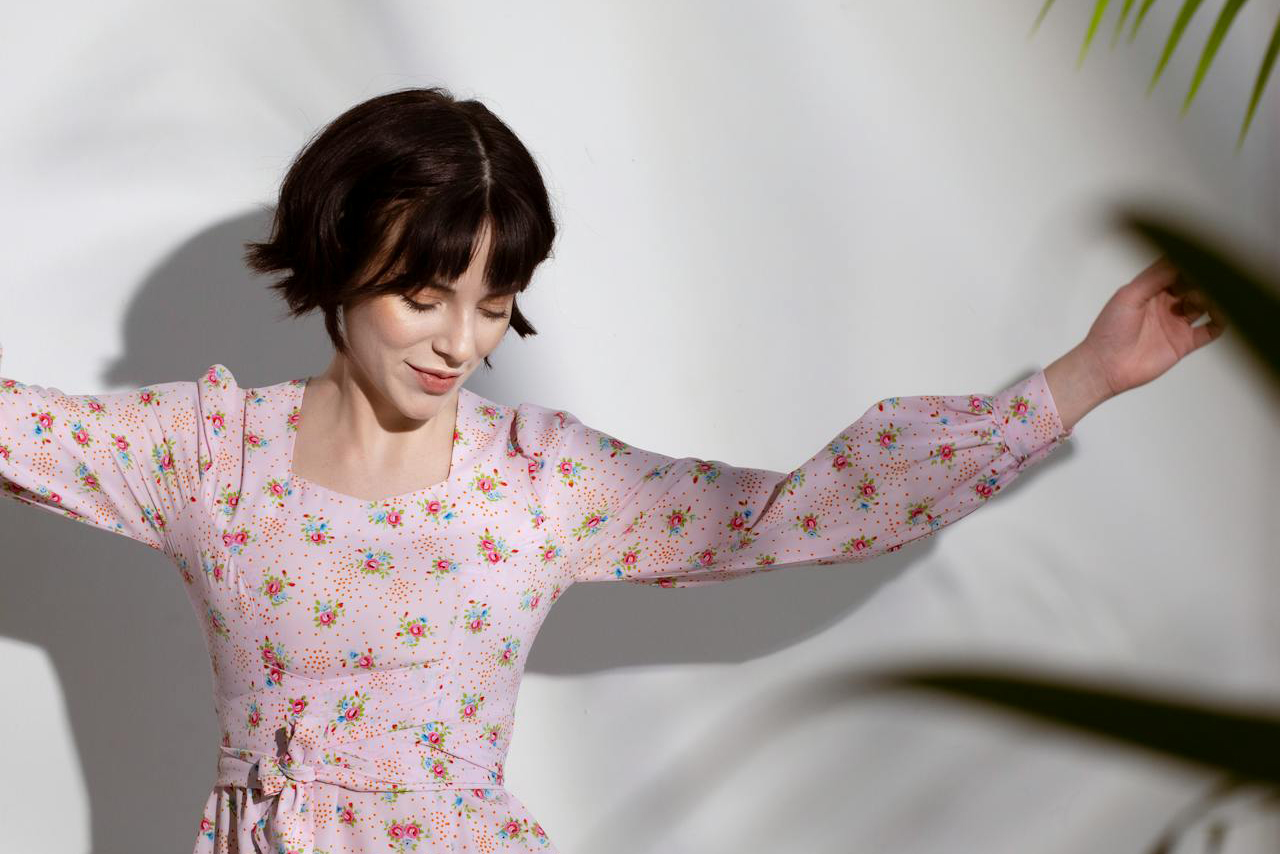 brunette woman in pink dress dancing